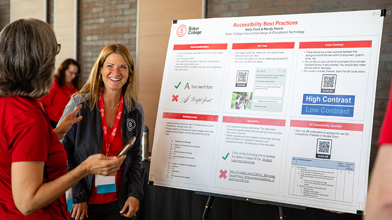 Baker College staff members presenting a poster board of accessibility best practices.