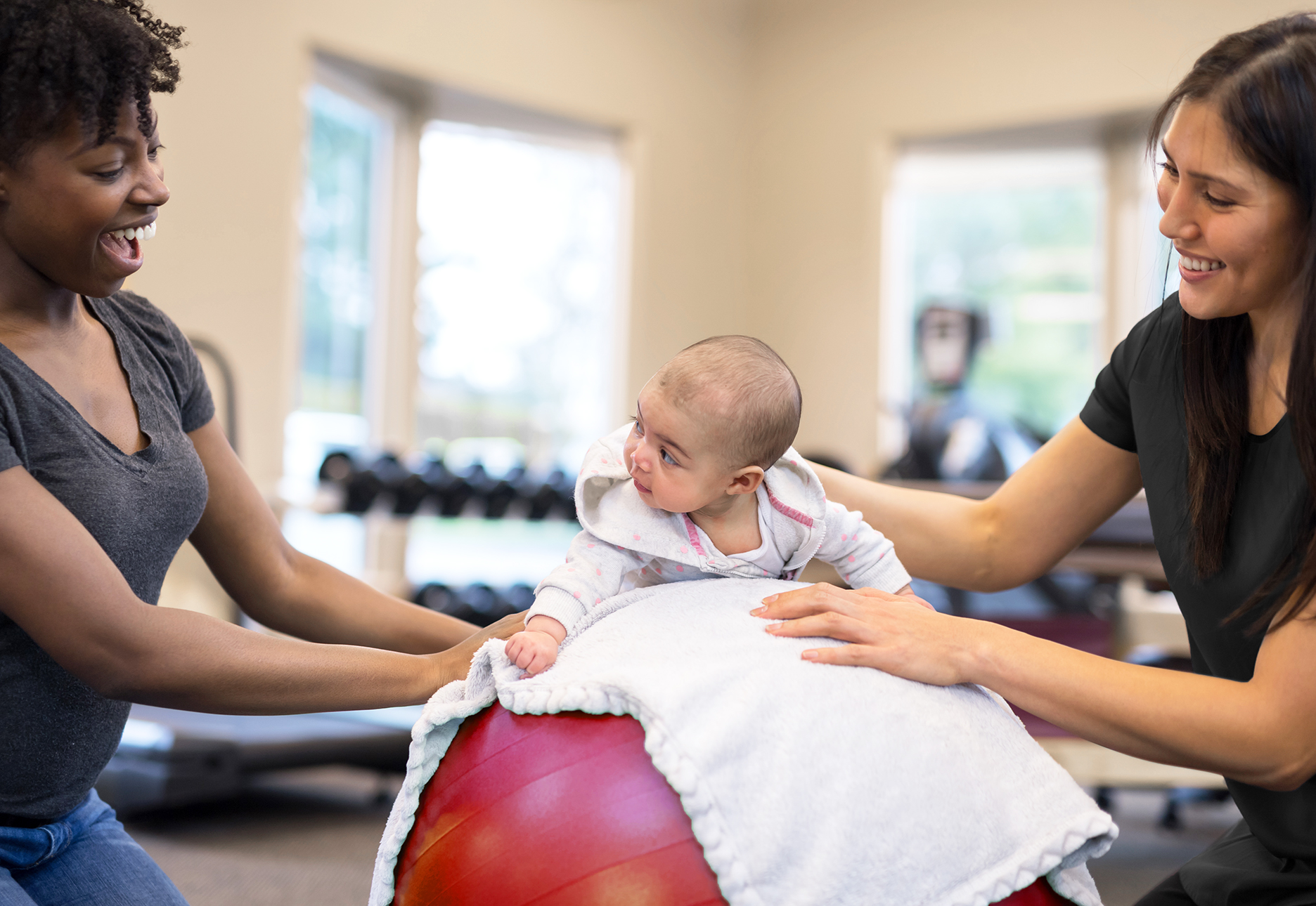 Occupational Therapists with baby on a ball